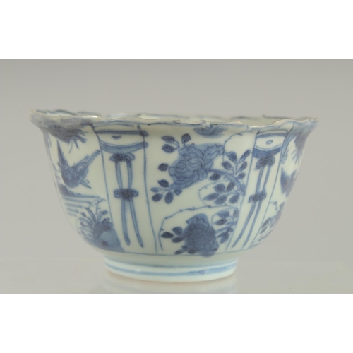 5 - AN 18TH CENTURY NANKING CARGO BLUE AND WHITE PORCELAIN BOWL, decorated with panels of flora and bird... 