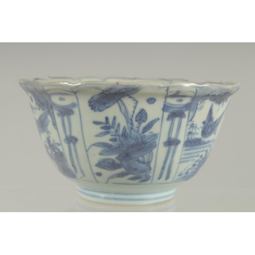 5 - AN 18TH CENTURY NANKING CARGO BLUE AND WHITE PORCELAIN BOWL, decorated with panels of flora and bird... 