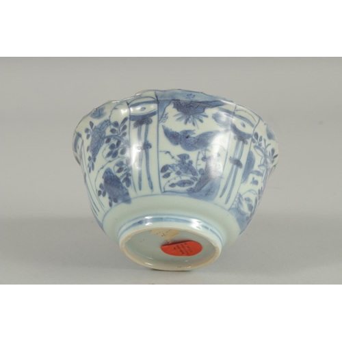 5 - AN 18TH CENTURY NANKING CARGO BLUE AND WHITE PORCELAIN BOWL, decorated with panels of flora and bird... 