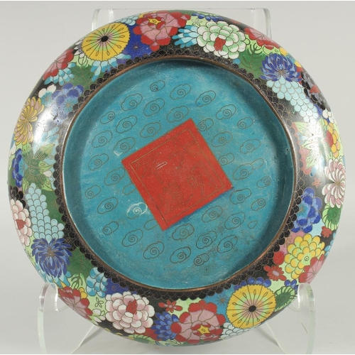 51 - A LARGE CHINESE CLOISONNE BOWL, decorated all over with various colourful flower heads, the base wit... 