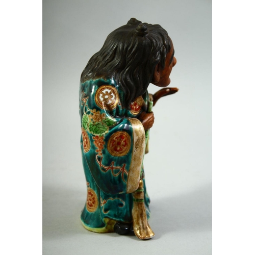 55 - A JAPANESE KUTANI POTTERY FIGURE of Jittoku, 20.5cm high.