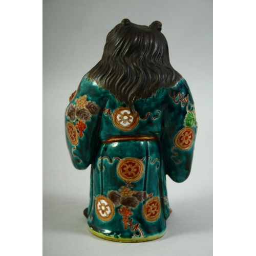 55 - A JAPANESE KUTANI POTTERY FIGURE of Jittoku, 20.5cm high.