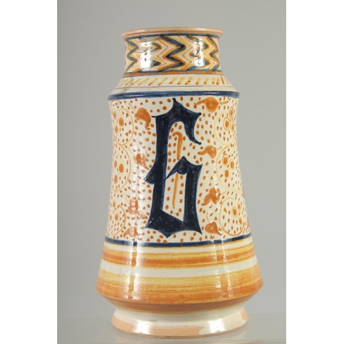 551 - AN ITALIAN GLAZED POTTERY MEDICINE JAR, 24.5cm high.