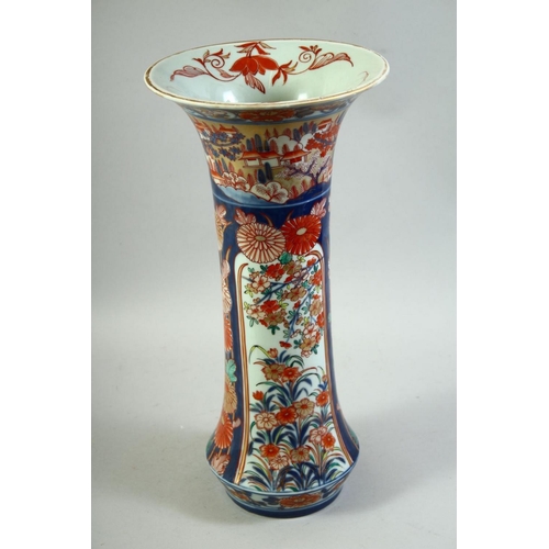 59 - A LARGE JAPANESE IMARI PORCELAIN SLEEVE VASE, painted with a village landscape with panels of flower... 