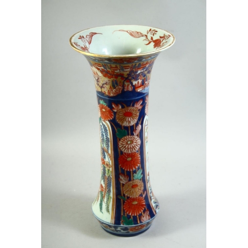 59 - A LARGE JAPANESE IMARI PORCELAIN SLEEVE VASE, painted with a village landscape with panels of flower... 