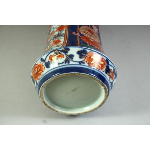 59 - A LARGE JAPANESE IMARI PORCELAIN SLEEVE VASE, painted with a village landscape with panels of flower... 