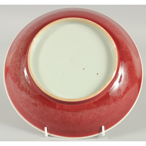 61 - A CHINESE COPPER RED GLZE PORCELAIN DISH, 22cm diameter.