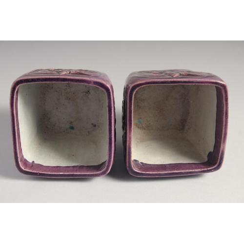 71 - A PAIR OF EARLY 20TH CENTURY CHINESE PURPLE GLAZE FLOWER POTS, with panels of relief decoration and ... 