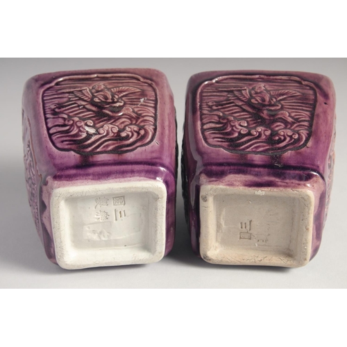 71 - A PAIR OF EARLY 20TH CENTURY CHINESE PURPLE GLAZE FLOWER POTS, with panels of relief decoration and ... 