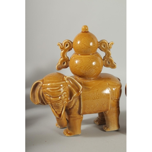 73 - A PAIR OF CHINESE YELLOW GLAZE POTTERY ELEPHANTS, each approx. 22cm long.