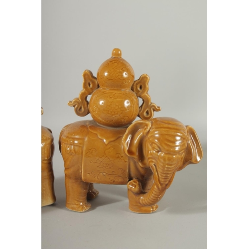 73 - A PAIR OF CHINESE YELLOW GLAZE POTTERY ELEPHANTS, each approx. 22cm long.