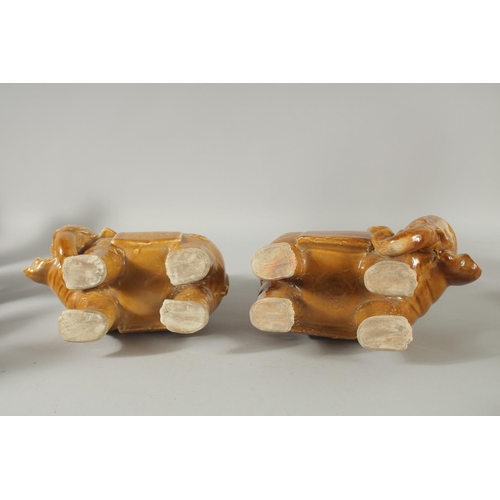 73 - A PAIR OF CHINESE YELLOW GLAZE POTTERY ELEPHANTS, each approx. 22cm long.