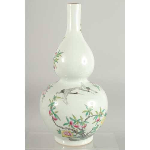 76 - A CHINESE FAMILLE ROSE PORCELAIN DOUBLE GOURD VASE, decorated with cranes and peach blossom, base wi... 