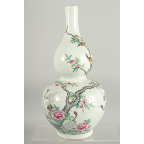 76 - A CHINESE FAMILLE ROSE PORCELAIN DOUBLE GOURD VASE, decorated with cranes and peach blossom, base wi... 