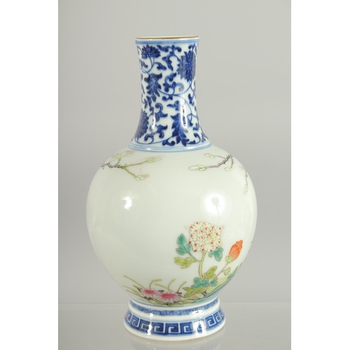 77 - A CHINESE FAMILLE ROSE / BLUE AND WHITE VASE, 19cm high.