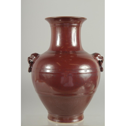 79 - A CHINESE MOTTLED RED GLAZE TWIN HANDLE VASE, with impressed mark to base, 25cm high.