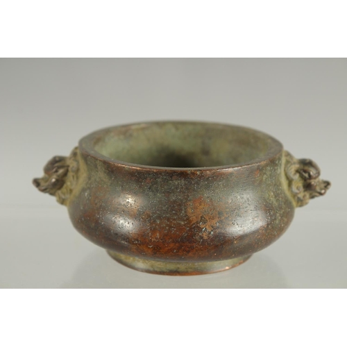 83 - A SMALL CHINESE TWIN HANDLE BRONZE CENSER, 10cm wide.