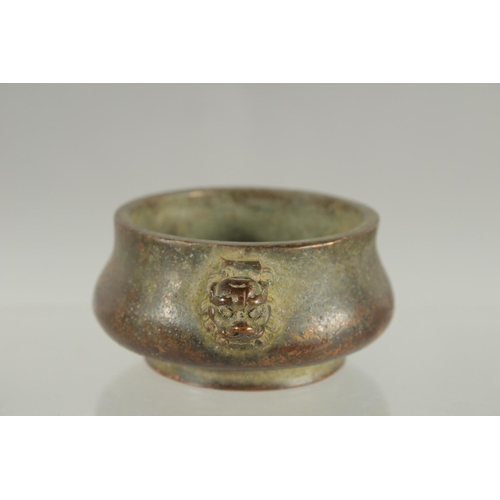 83 - A SMALL CHINESE TWIN HANDLE BRONZE CENSER, 10cm wide.