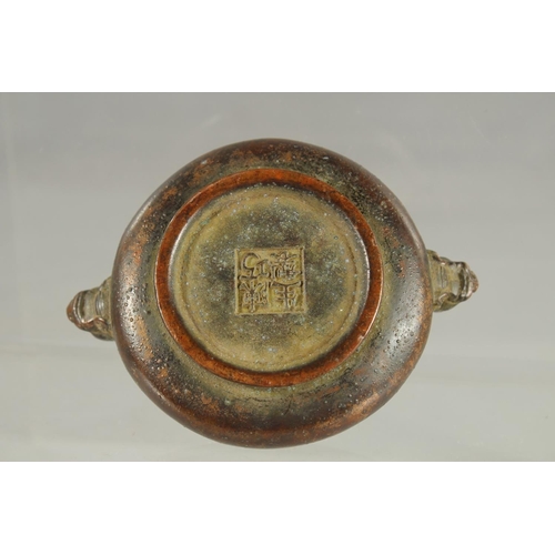 83 - A SMALL CHINESE TWIN HANDLE BRONZE CENSER, 10cm wide.