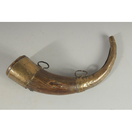 84 - A BRASS MOUNTED BOVINE HORN, 28cm long.