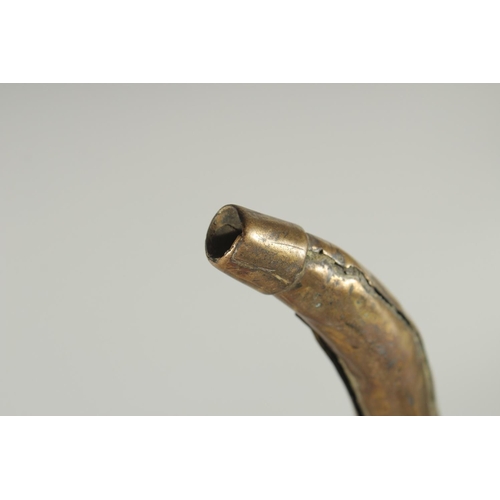 84 - A BRASS MOUNTED BOVINE HORN, 28cm long.