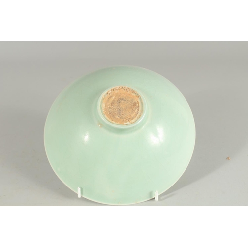 87 - A CHINESE CELADON BOWL, with incised decoration, 20.5cm diameter.