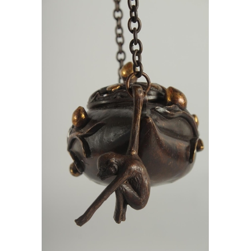 88 - A CHINESE GILDED BRONZE HANGING CENSER AND COVER, with hanging monkey figure, 11.5cm wide.