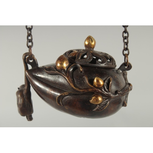 88 - A CHINESE GILDED BRONZE HANGING CENSER AND COVER, with hanging monkey figure, 11.5cm wide.