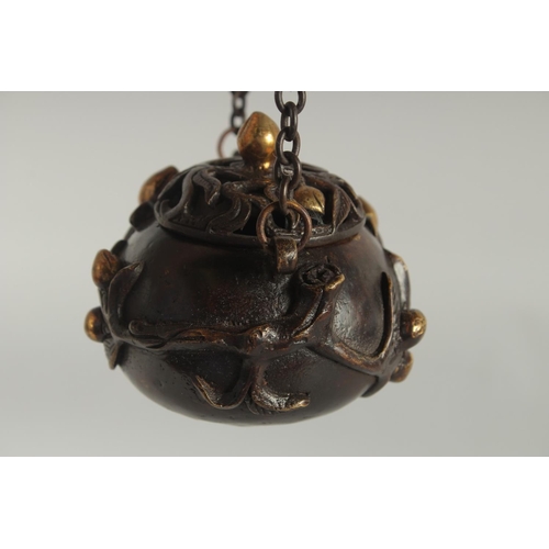 88 - A CHINESE GILDED BRONZE HANGING CENSER AND COVER, with hanging monkey figure, 11.5cm wide.