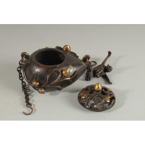 88 - A CHINESE GILDED BRONZE HANGING CENSER AND COVER, with hanging monkey figure, 11.5cm wide.