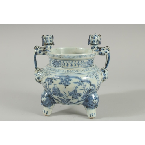 90 - A CHINESE BLUE AND WHITE PORCELAIN TRIPOD CENSER, with moulded dog handles, 20.5cm high.