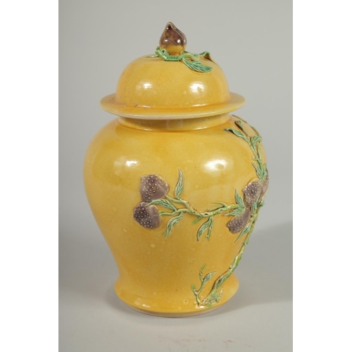 92 - A CHINESE QING DYNASTY YELLOW GROUND SANCAI GINGER JAR AND COVER, relief decorated with blossoming p... 