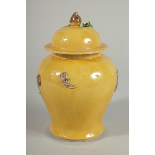 92 - A CHINESE QING DYNASTY YELLOW GROUND SANCAI GINGER JAR AND COVER, relief decorated with blossoming p... 