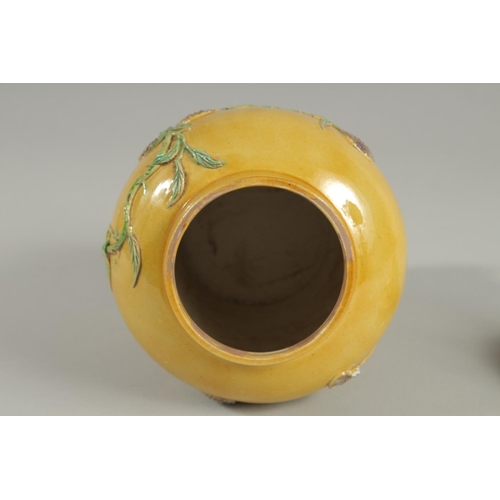 92 - A CHINESE QING DYNASTY YELLOW GROUND SANCAI GINGER JAR AND COVER, relief decorated with blossoming p... 