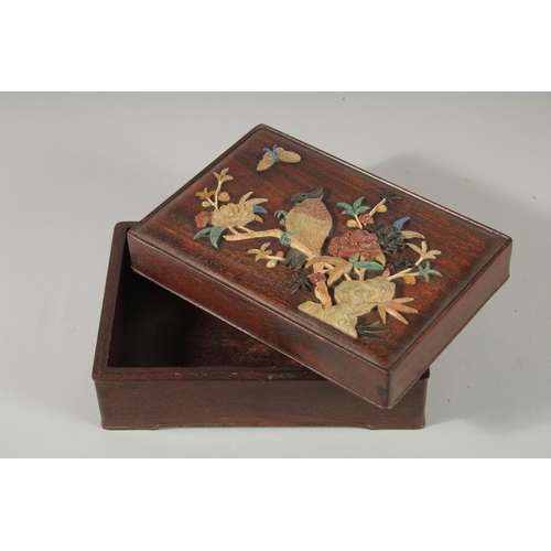 94 - A CHINESE MOTHER OF PEARL AND HARDSTONE MOUNTED ROSEWOOD BOX, the lid decorated with various carved ... 