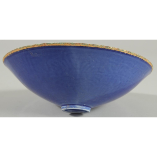 96 - A CHINESE BLUE GROUND CARVED FLORAL BOWL, character mark to base, 20cm diameter.