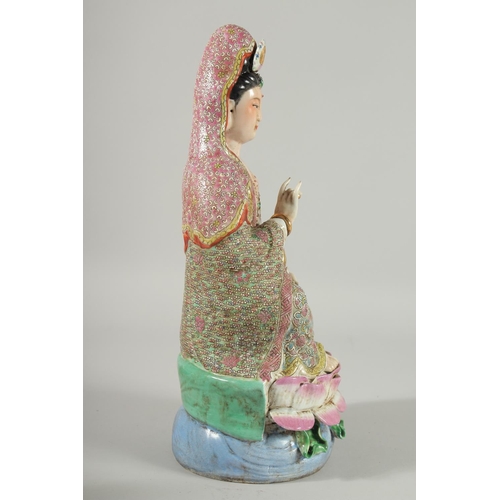 99 - A CHINESE FAMILLE ROSE PORCELAIN GUANYIN FIGURE, seated upon a lotus base, impressed mark beneath, 3... 