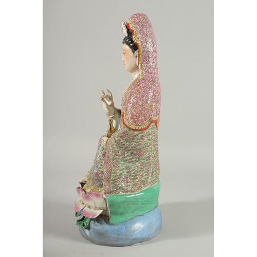 99 - A CHINESE FAMILLE ROSE PORCELAIN GUANYIN FIGURE, seated upon a lotus base, impressed mark beneath, 3... 