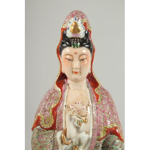 99 - A CHINESE FAMILLE ROSE PORCELAIN GUANYIN FIGURE, seated upon a lotus base, impressed mark beneath, 3... 