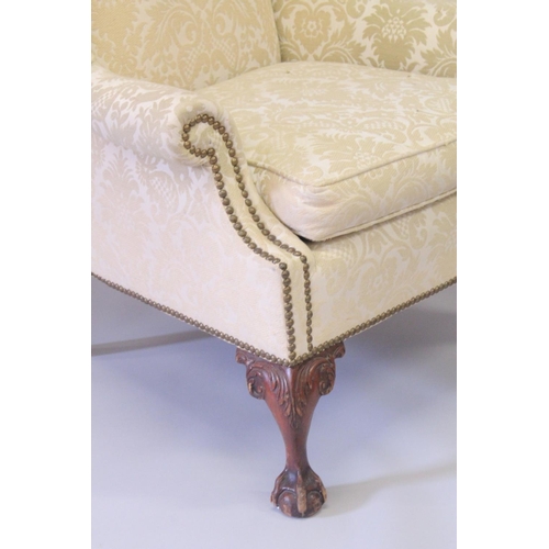 1019 - A GOOD MAHOGANY WING ARM CHAIR on cabriole legs ending in claw and ball feet.