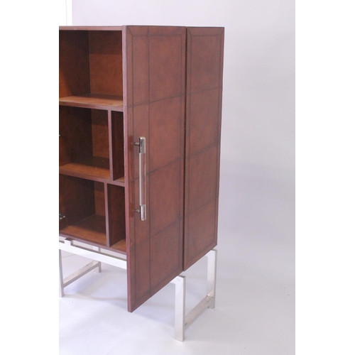 1029 - A TAN LEATHER AND CHROME BAR CABINET with double panel doors 5ft 4ins high, 3ft wide, 1ft 4ins deep.... 