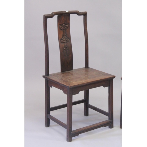 1032 - A PAIR OF CHINESE HARDWOOD CHAIRS with carved panel backs. 3ft 7ins high.