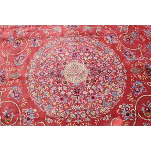 1035 - A VERY GOOD ISLAMIC CARPET, 20TH CENTURY, salmon pink with a rich blue border, having an allover des... 