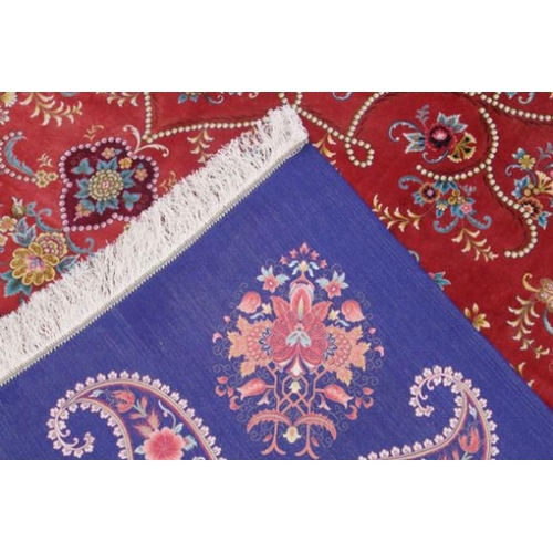 1035 - A VERY GOOD ISLAMIC CARPET, 20TH CENTURY, salmon pink with a rich blue border, having an allover des... 