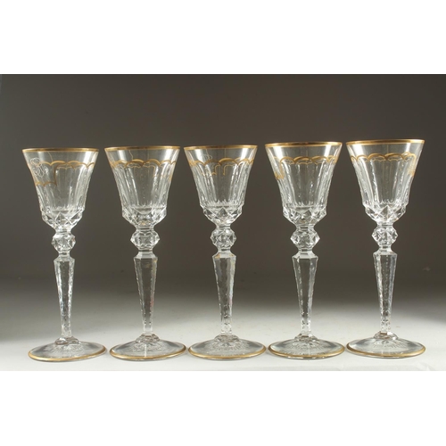 1102 - A GOOD SET OF FIVE BACCARAT CUT GLASS AND GILDED GOBLETS Inlaid J. B. 10ins high.