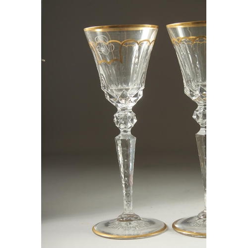 1102 - A GOOD SET OF FIVE BACCARAT CUT GLASS AND GILDED GOBLETS Inlaid J. B. 10ins high.