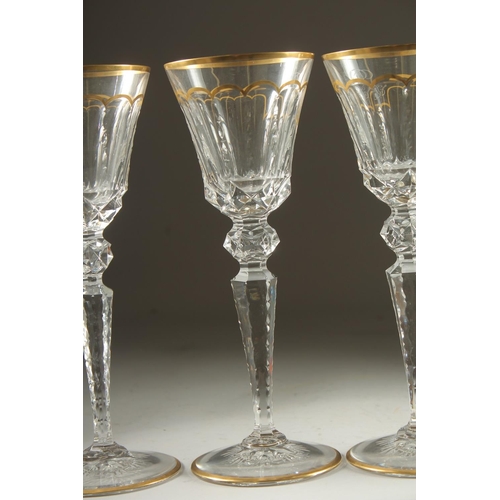 1102 - A GOOD SET OF FIVE BACCARAT CUT GLASS AND GILDED GOBLETS Inlaid J. B. 10ins high.