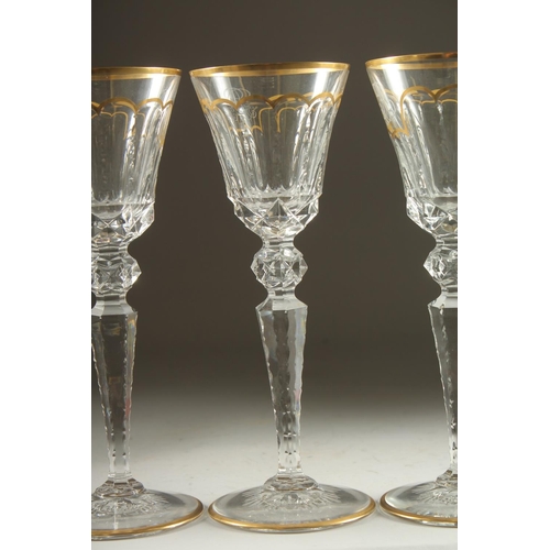 1102 - A GOOD SET OF FIVE BACCARAT CUT GLASS AND GILDED GOBLETS Inlaid J. B. 10ins high.