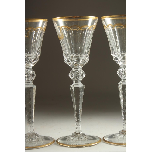 1102 - A GOOD SET OF FIVE BACCARAT CUT GLASS AND GILDED GOBLETS Inlaid J. B. 10ins high.