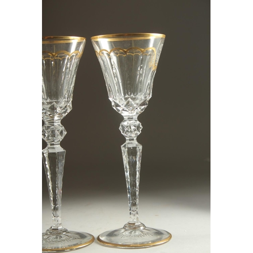 1102 - A GOOD SET OF FIVE BACCARAT CUT GLASS AND GILDED GOBLETS Inlaid J. B. 10ins high.